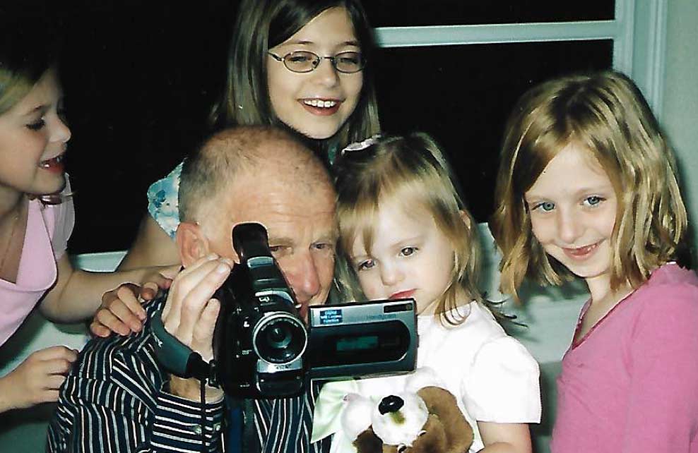Gene with video camera and grandkids